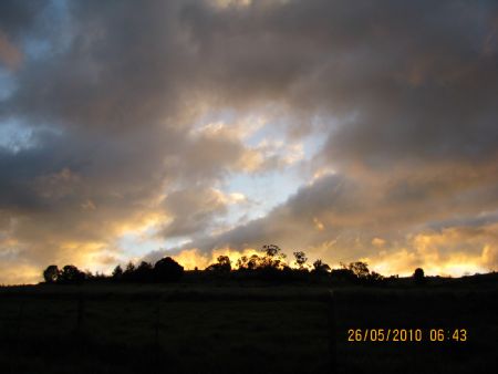 Storm Clouds gather at sunrise behind the house
