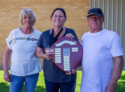 Jamie with shield flanked by other club members