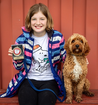 Eva with her award and dog, Charlie